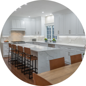 Kitchen remodel featuring marble waterfall island, white cabinetry, stainless appliances, hardwood flooring by California HarborCrest Kitchen Design